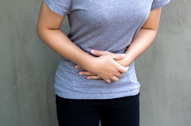 Young woman having a menstruation pain 