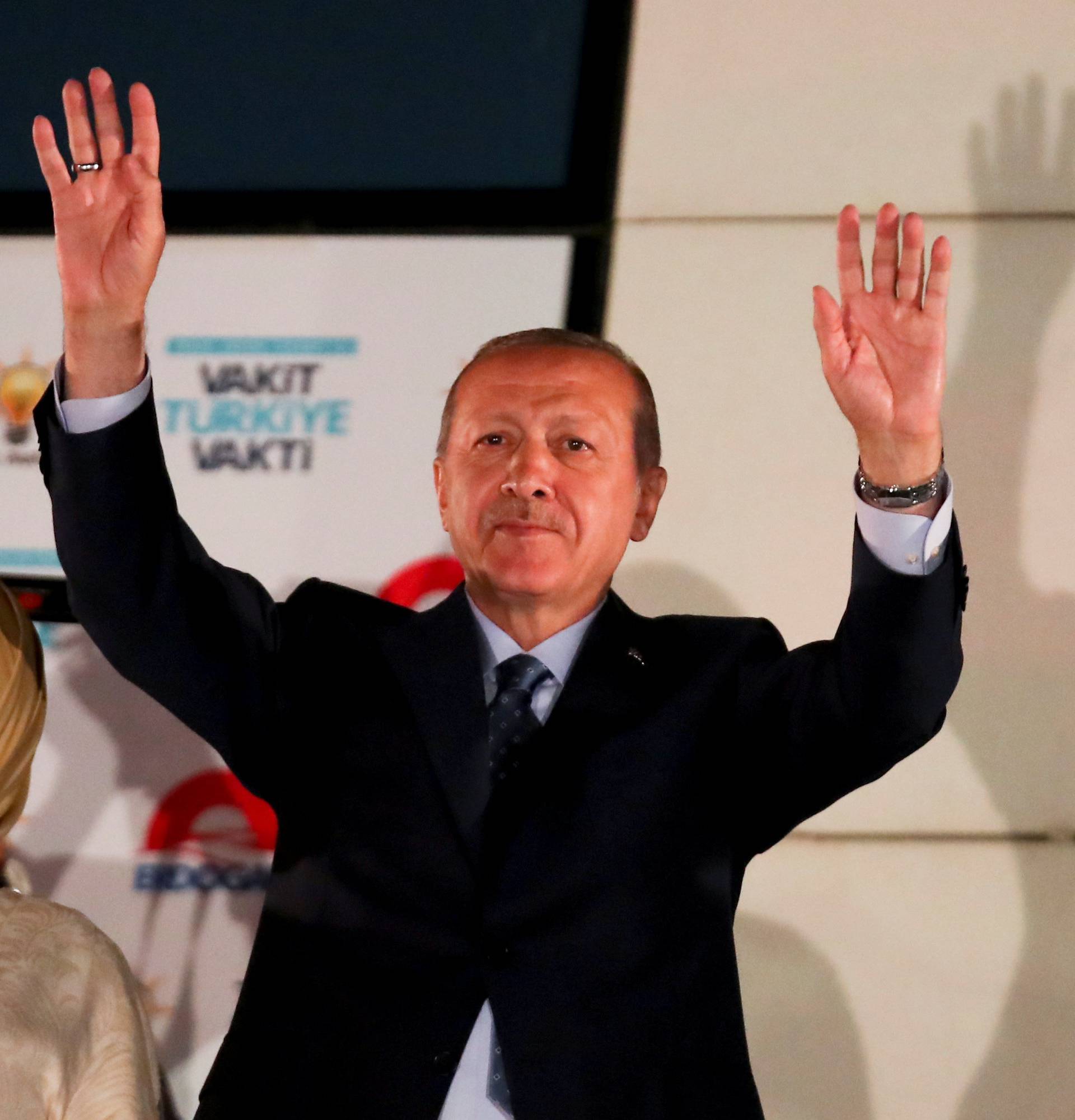 Turkish President Tayyip Erdogan and his wife Emine Erdogan greet supporters gathered in front of the AKP headquarters in Ankara