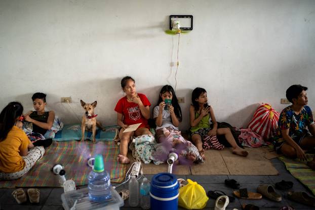 People take shelter at an evacuation site in preparation for super typhoon Man-yi, in Manila