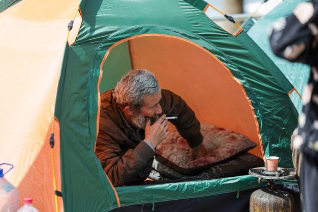 Displaced civilians set up tents along a roadside by the sea, following an escalation between Hezbollah and Israel, in Beirut