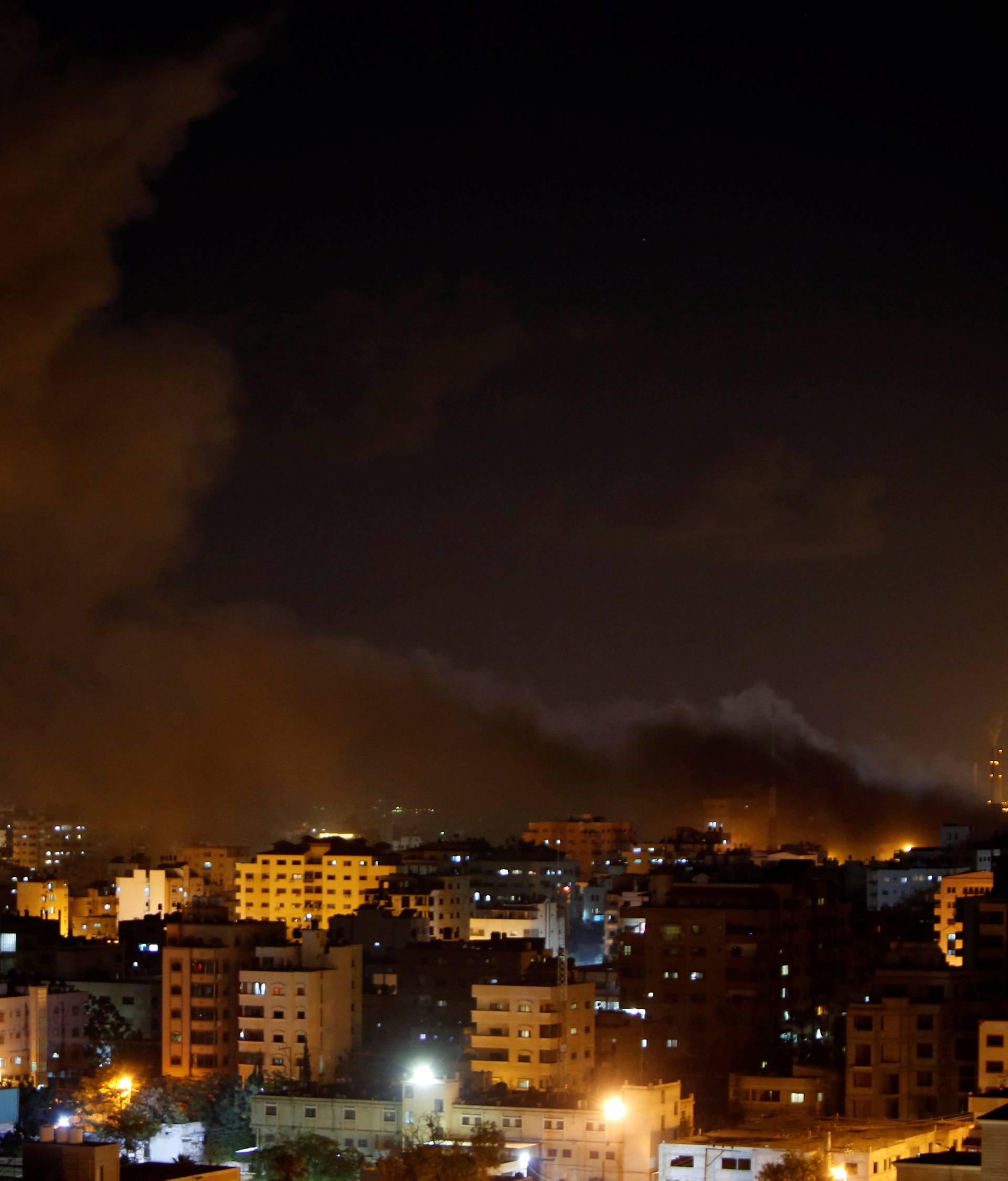 Smoke rises following an Israeli air strike on Hamas's television station, in Gaza City