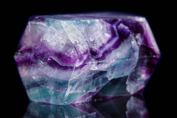 Macro mineral stone Fluorite crystal on a black background