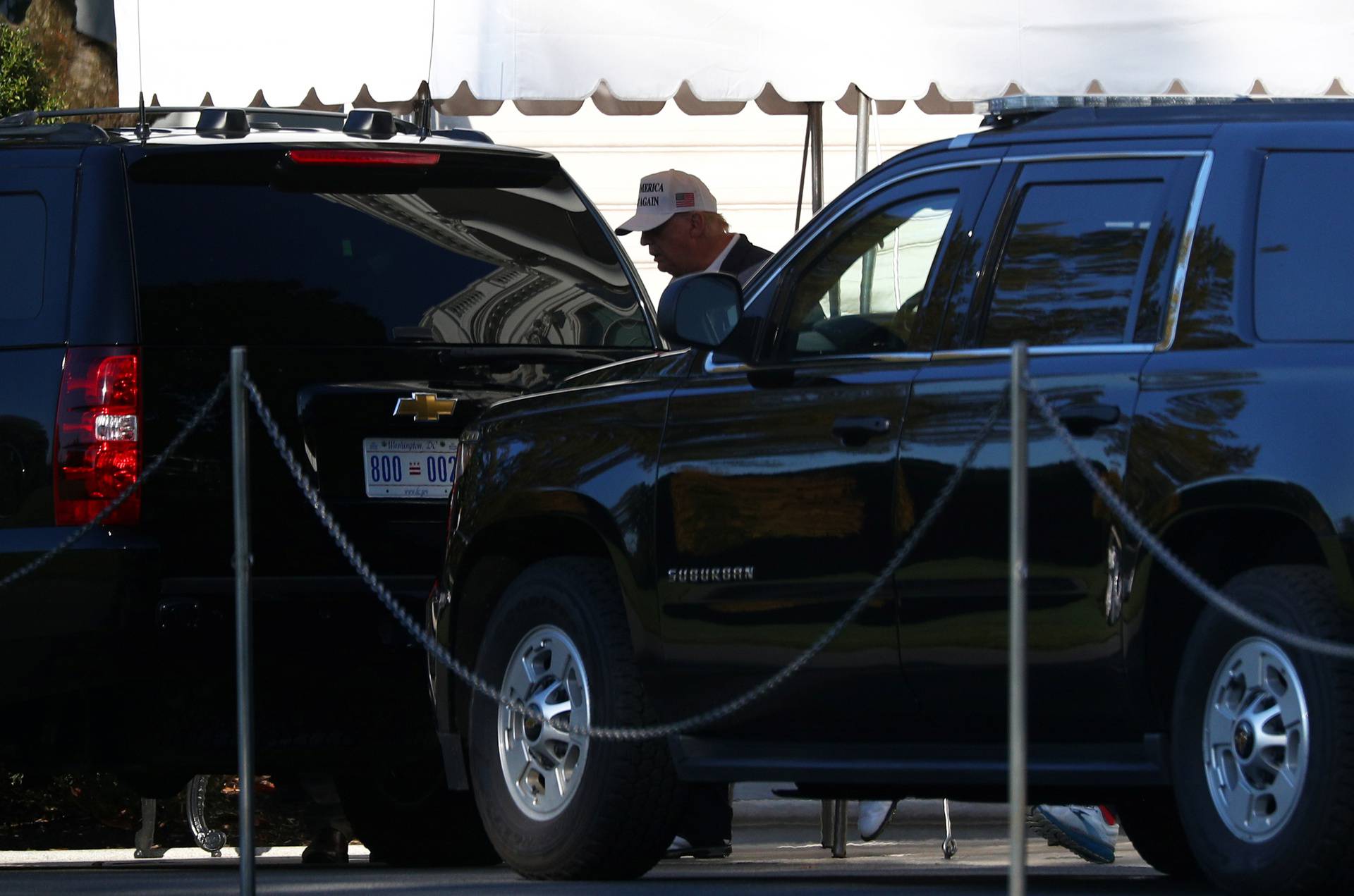 U.S. President Donald Trump enters the Presidential motorcade before traveling to an undisclosed location at the south portico of the White House in Washington