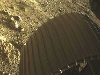 One of the six wheels aboard NASA’s Perseverance Mars rover is seen in a high-resolution, color image