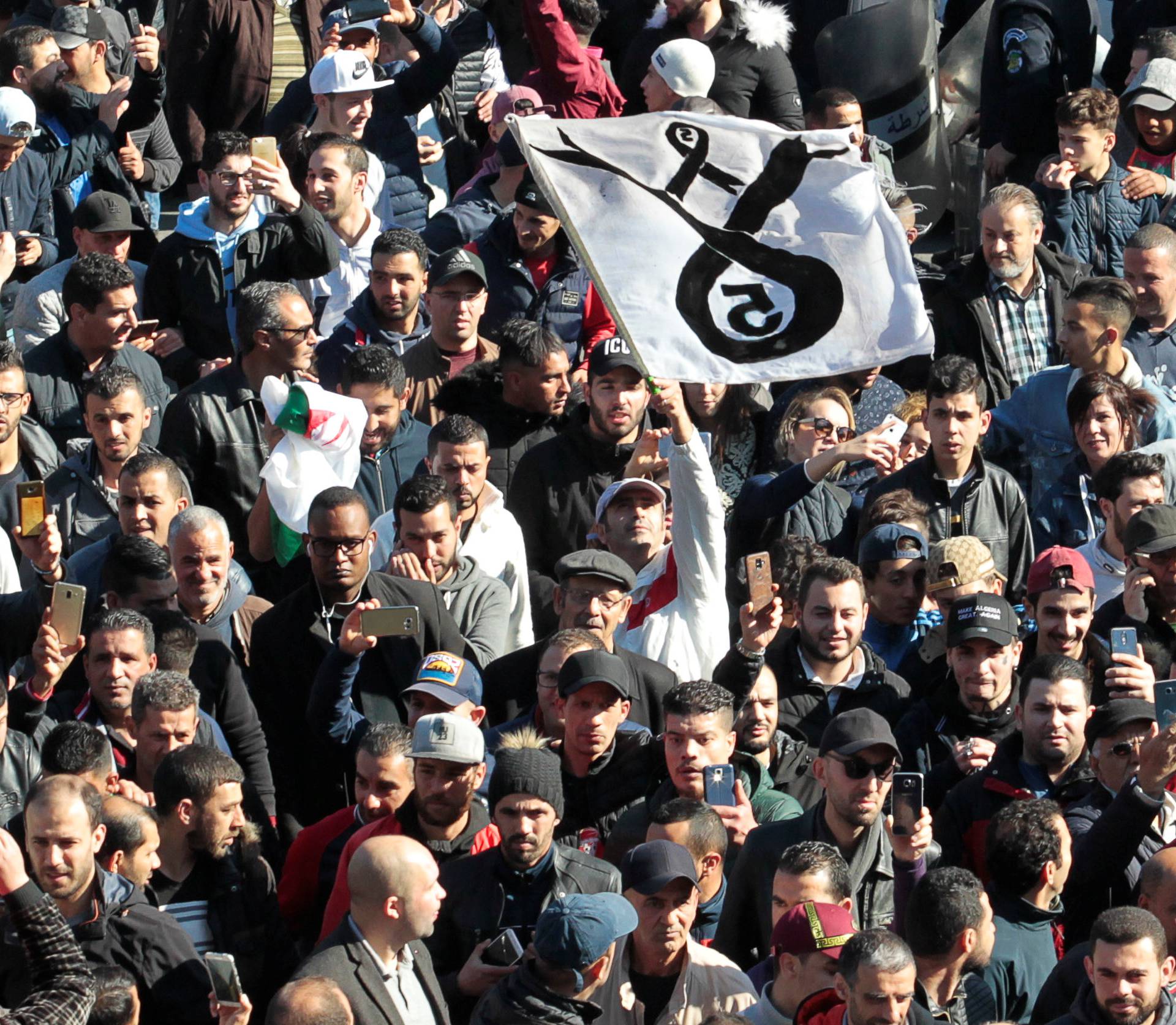 People march to protest against President Abdelaziz Bouteflika's plan to seek a fifth term in Algiers