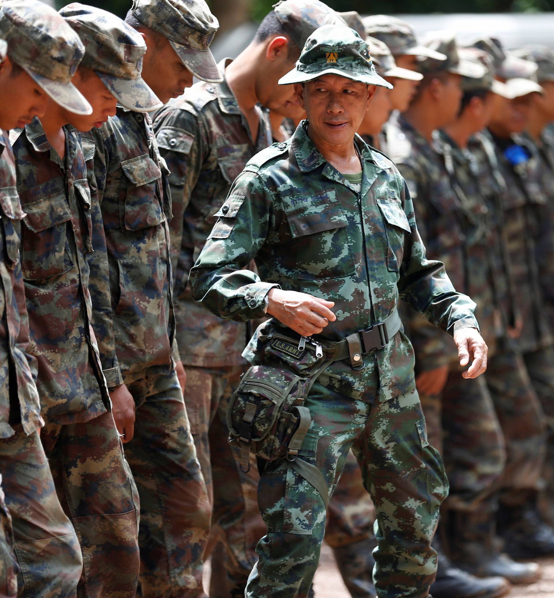 Soldiers stand during a drill near the Tham Luang cave complex, as members of an under-16 soccer team and their coach have been reported by local media to be found alive, in the northern province of Chiang Rai