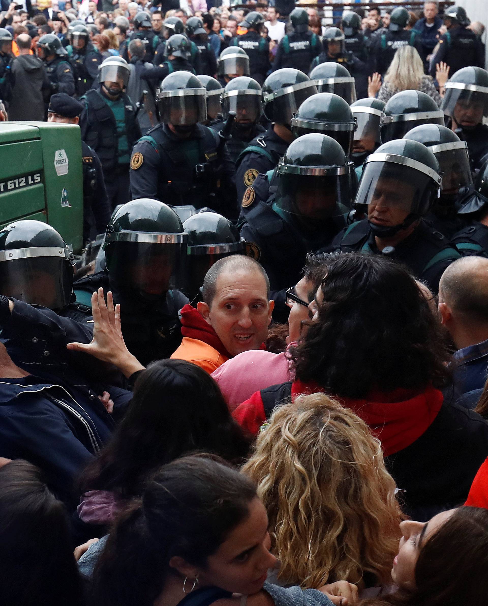 Scuffles break out as officers force their way through crowd and into polling station for Catalonia referendum in Sant Julia de Ramis