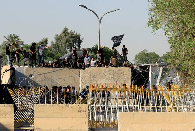 Supporters of Iraqi populist leader Moqtada al-Sadr protest at the Green Zone, in Baghdad