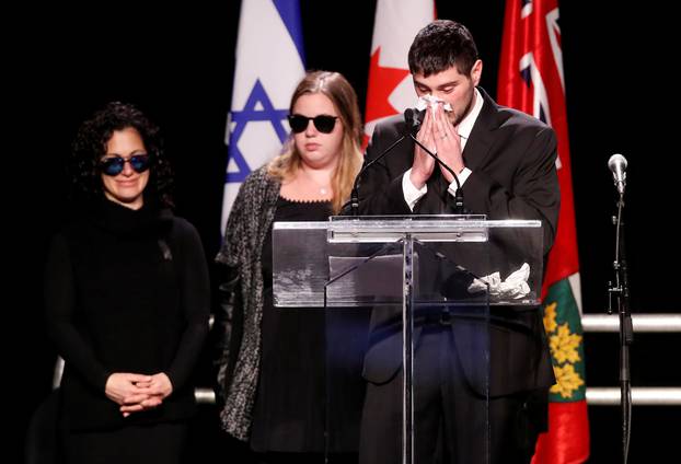 Jonathon Sherman speaks at a memorial service in front of other family members about his parents days after what police call their suspicious deaths in Toronto