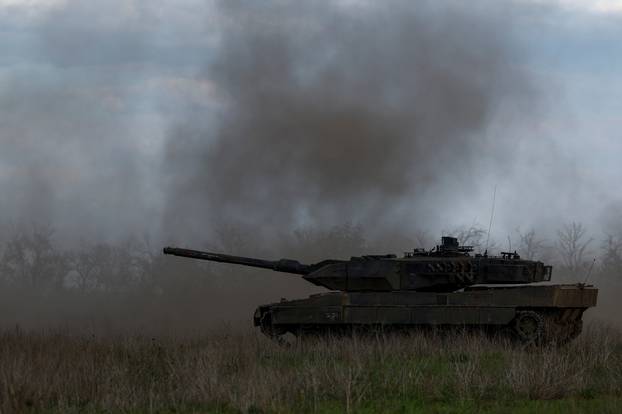 Ukrainian servicemen fire a Leopadr 2A6 tank during a military exercise in Donetsk region