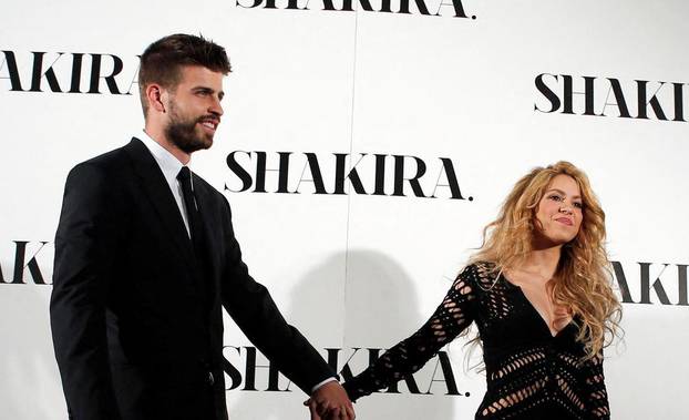 FILE PHOTO: Colombian singer Shakira and Barcelona's soccer player Gerard Pique pose during a photocall presenting her new album "Shakira" in Barcelona