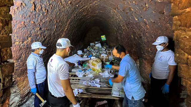 Representatives of Cambodia's authorities, prepare confiscated drugs for burning during a ceremony to mark the International Day against Drug Abuse in Phnom Penh