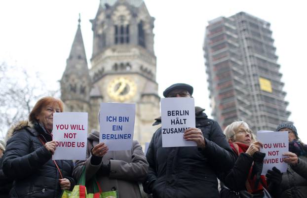 Berliners and refugees gather to sing "We Are The World" in front of the Kaiser Wilhelm Gedaechtniskirche in Berlin