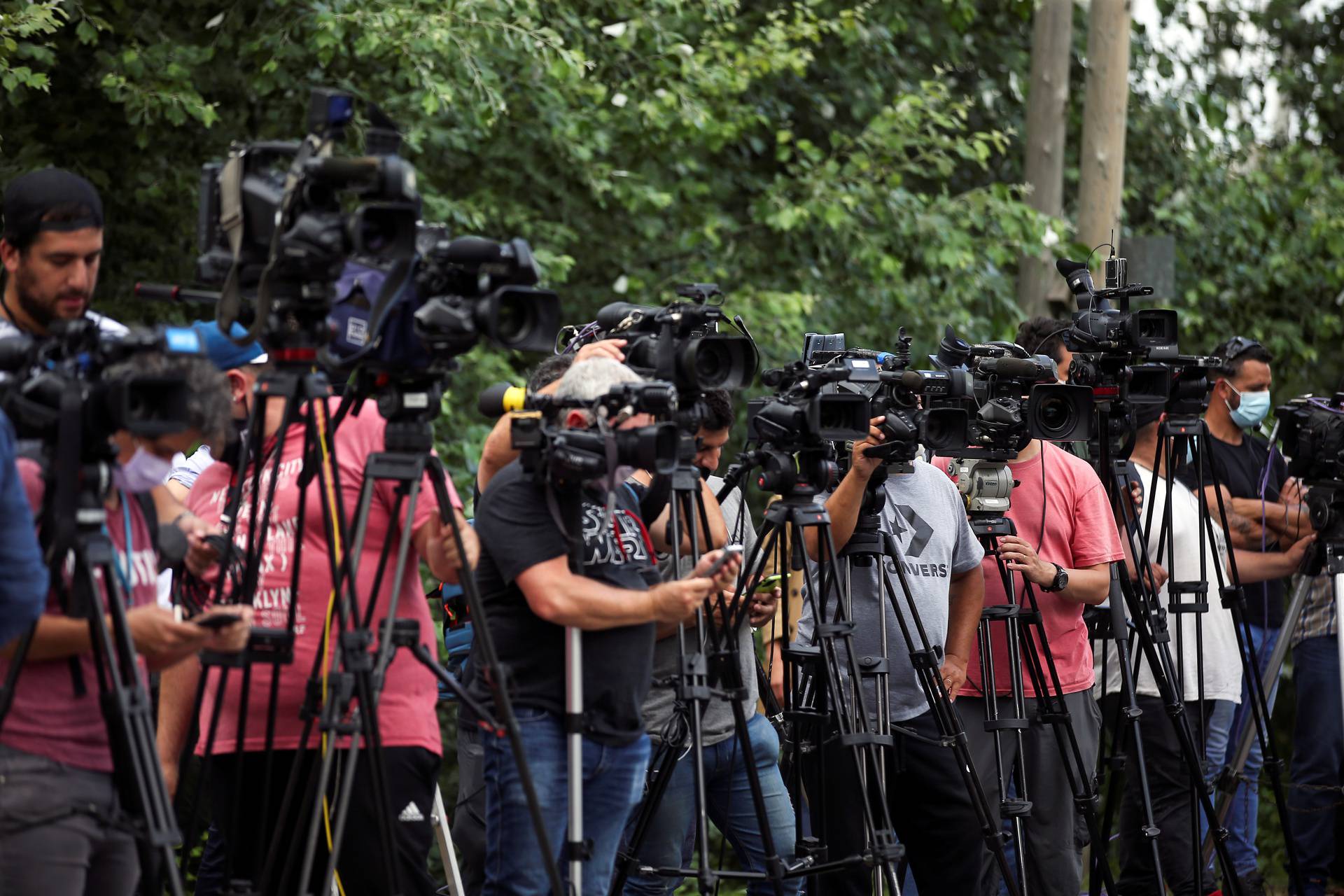 Members of the media stand outside the house where Diego Maradona was staying, in Tigre