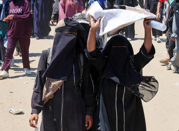 Palestinians seek aid from the U.S.-backed Gaza Humanitarian Foundation, near Rafah