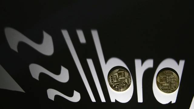 FILE PHOTO: FILE PHOTO: Shadow of a 3D-printed Facebook Libra cryptocurrency logo is seen near cryptocurrency representation in this illustration taken