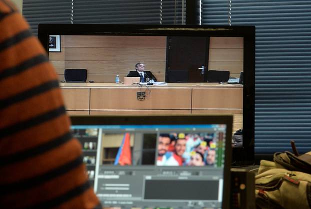 Jose Francisco Cobo, magistrate from the High Court of Navarra, is seen on screen as he delivers a nine-year prison sentence on five men accused of the multiple rape of a woman during Pamplona
