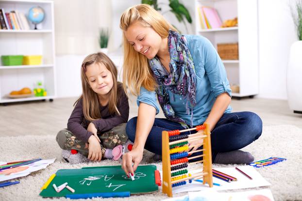 Young,Mother,And,Her,Daughter,Sitting,On,The,Floor,And