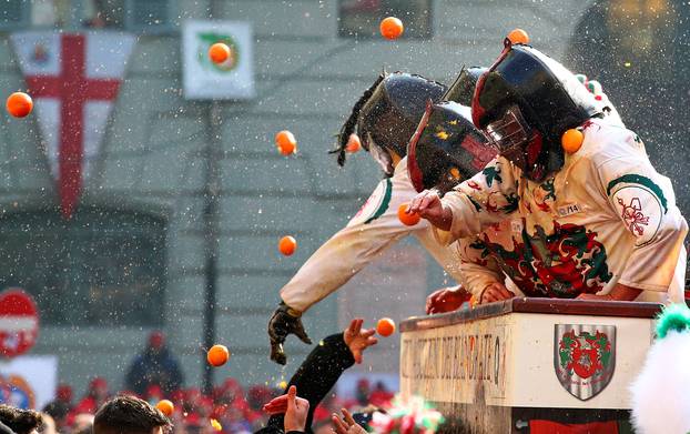 Members of rival teams fight with oranges during an annual carnival battle in the northern Italian town of Ivrea