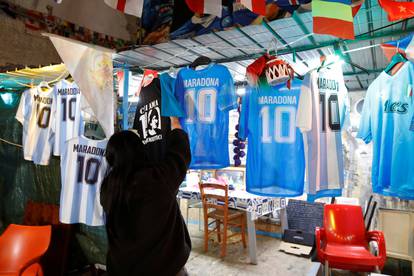 Replica jerseys of Argentine soccer legend Diego Maradona hang in the Spanish Quarter of Naples after the announcement of his death, in Naples