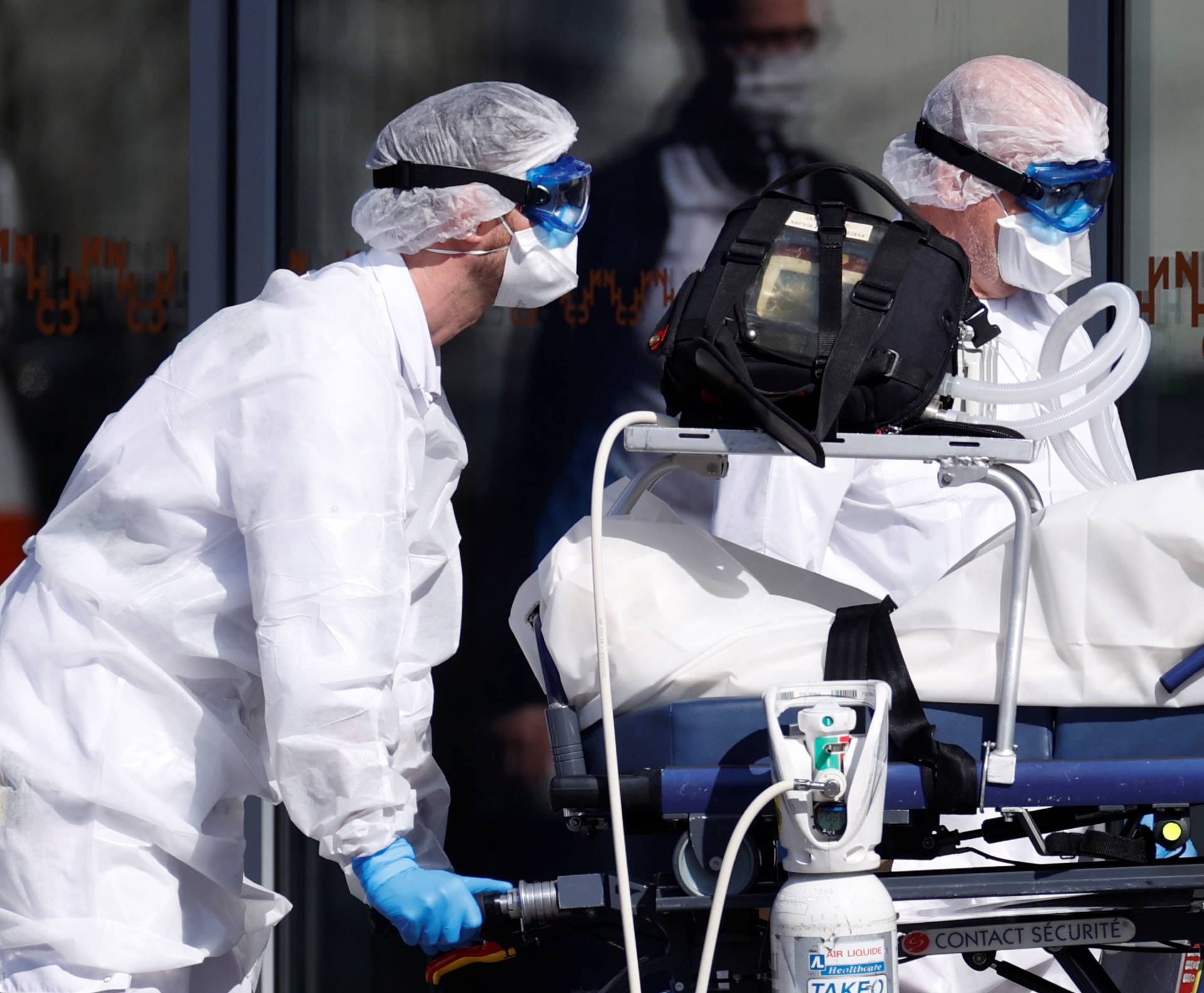 French SMUR rescue team wearing protective suits carry a patient at Strasbourg University hospital