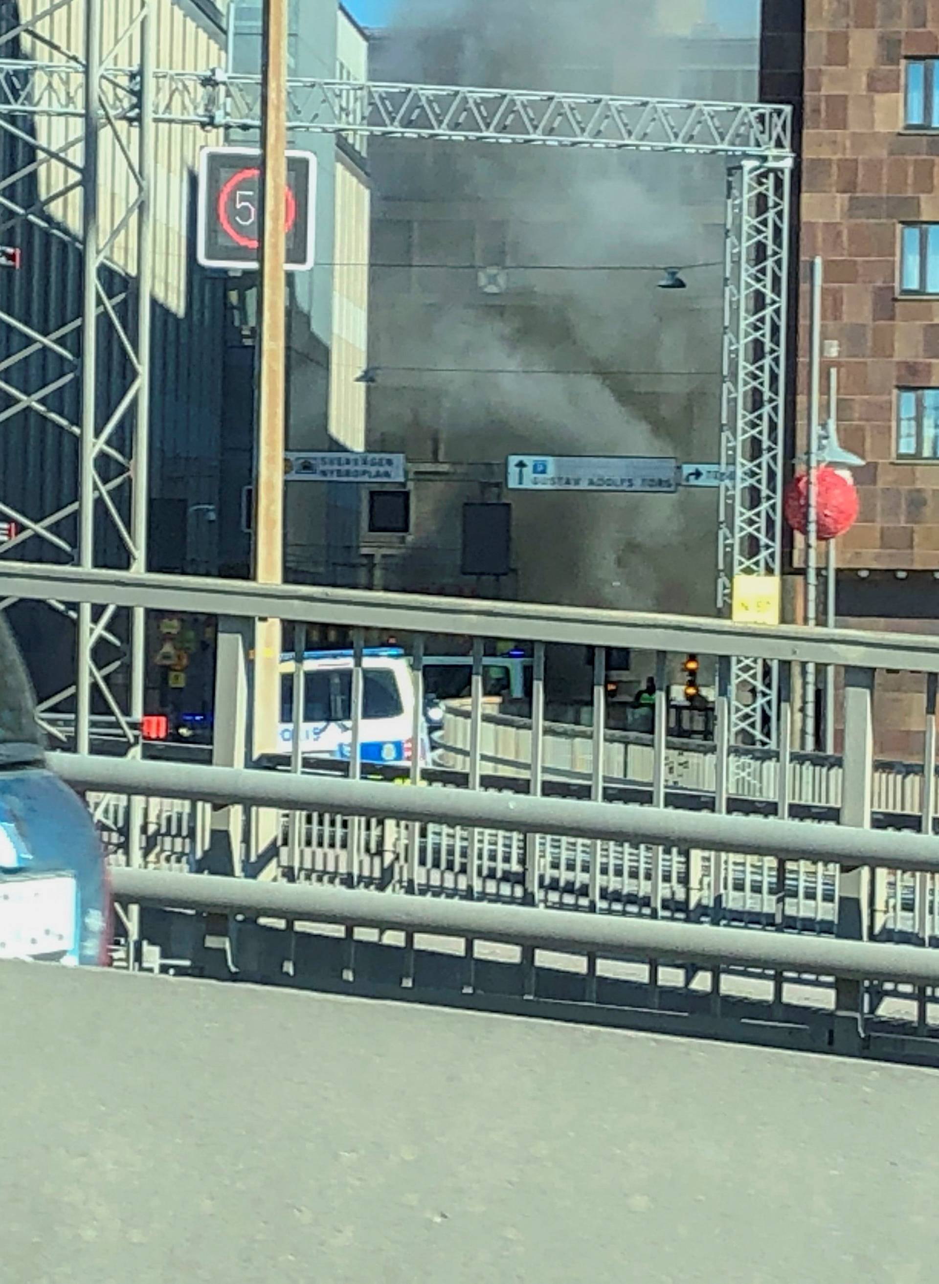 Smoke from a bus explosion and fire is seen in Tegelbacken in central Stockholm