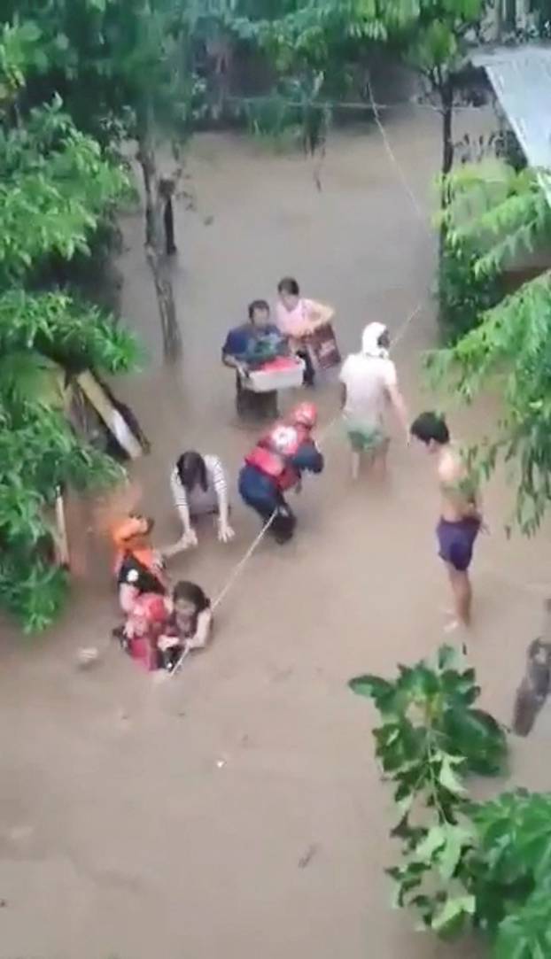 Rescuers help people affected by floods, in Gingoog city
