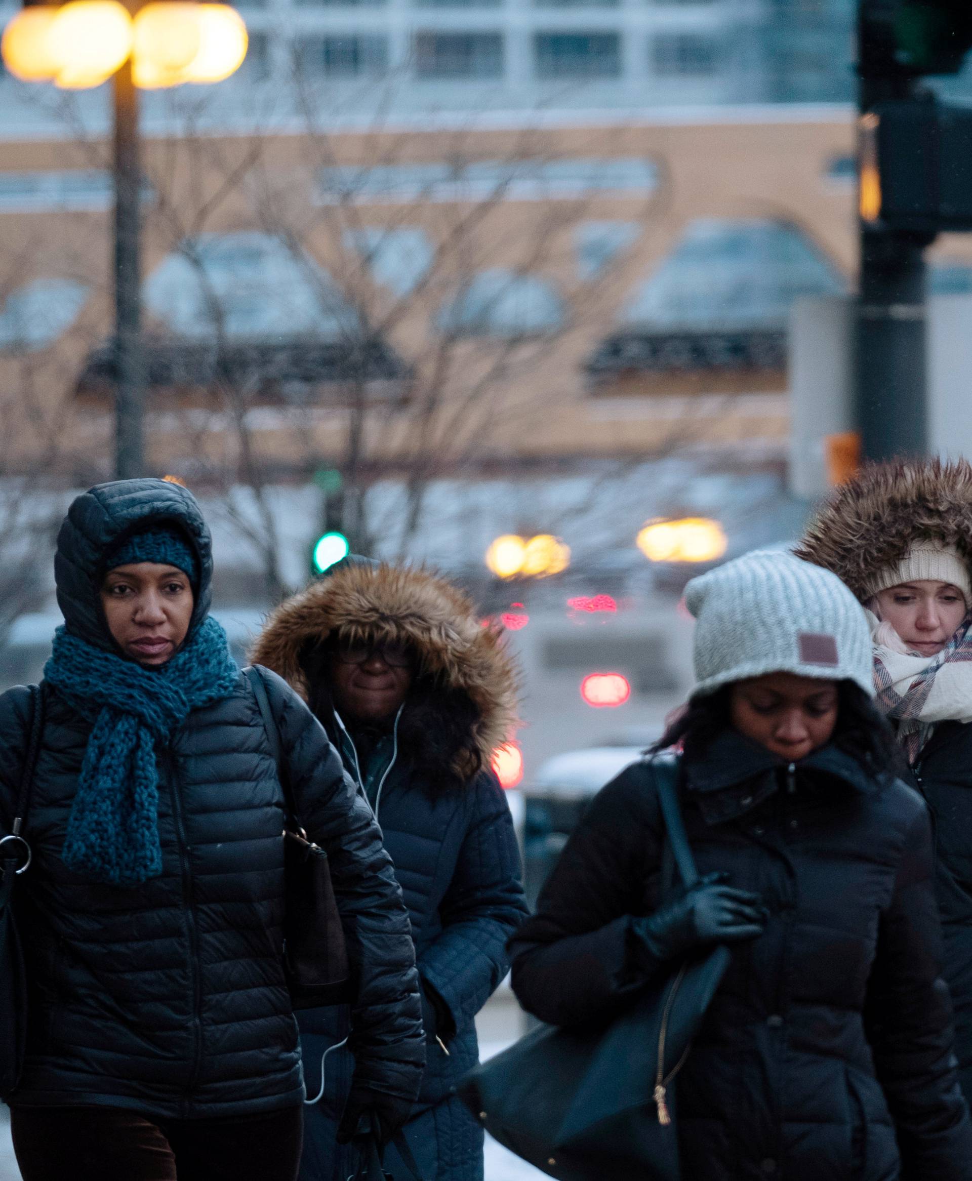 Pedestrians cross the street at rush hour as bitter cold phenomenon called the polar vortex has descended on much of the central and eastern United States