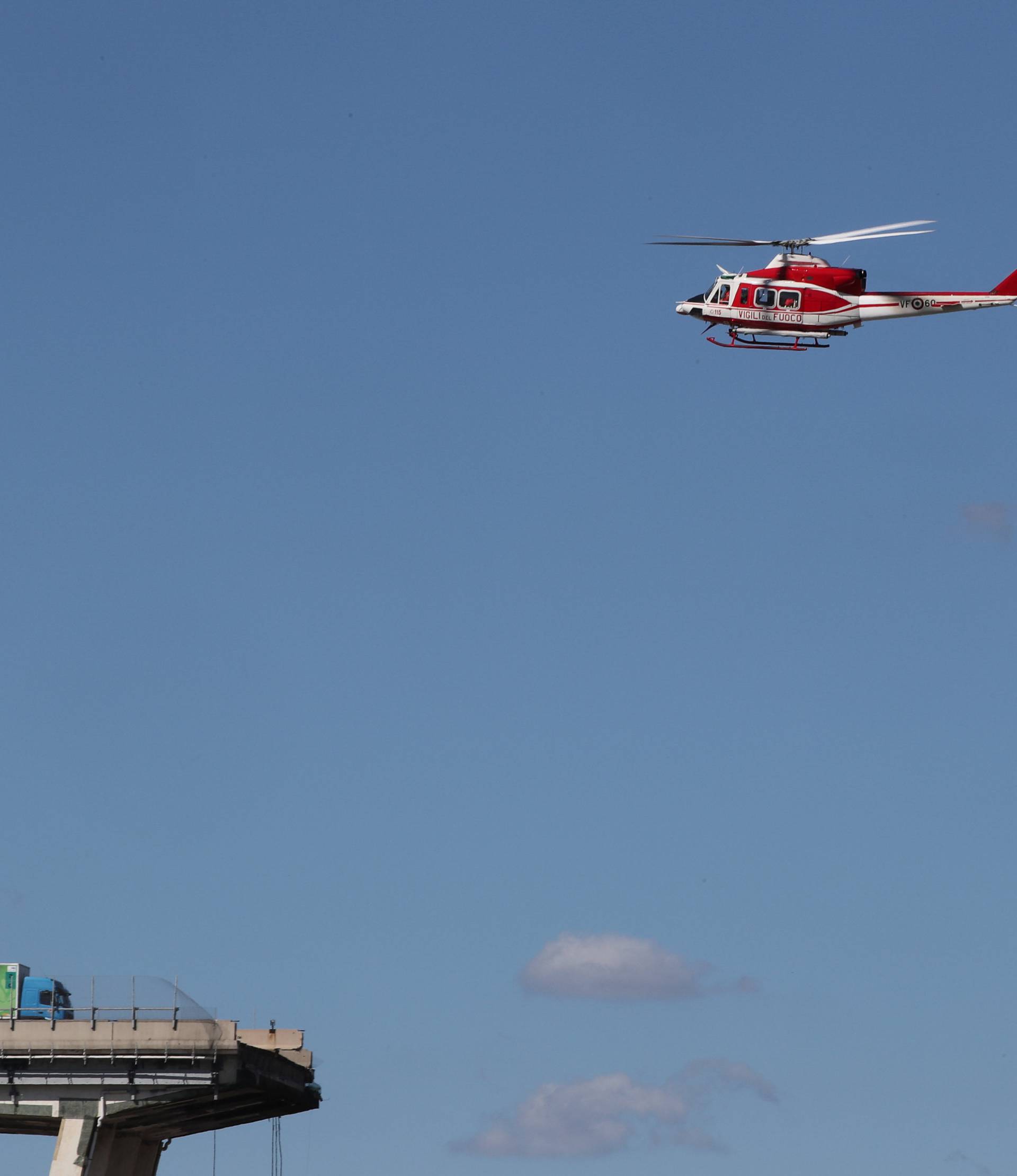 Firefighter helicopter flies over the collapsed Morandi Bridge in the Italian port city of Genoa