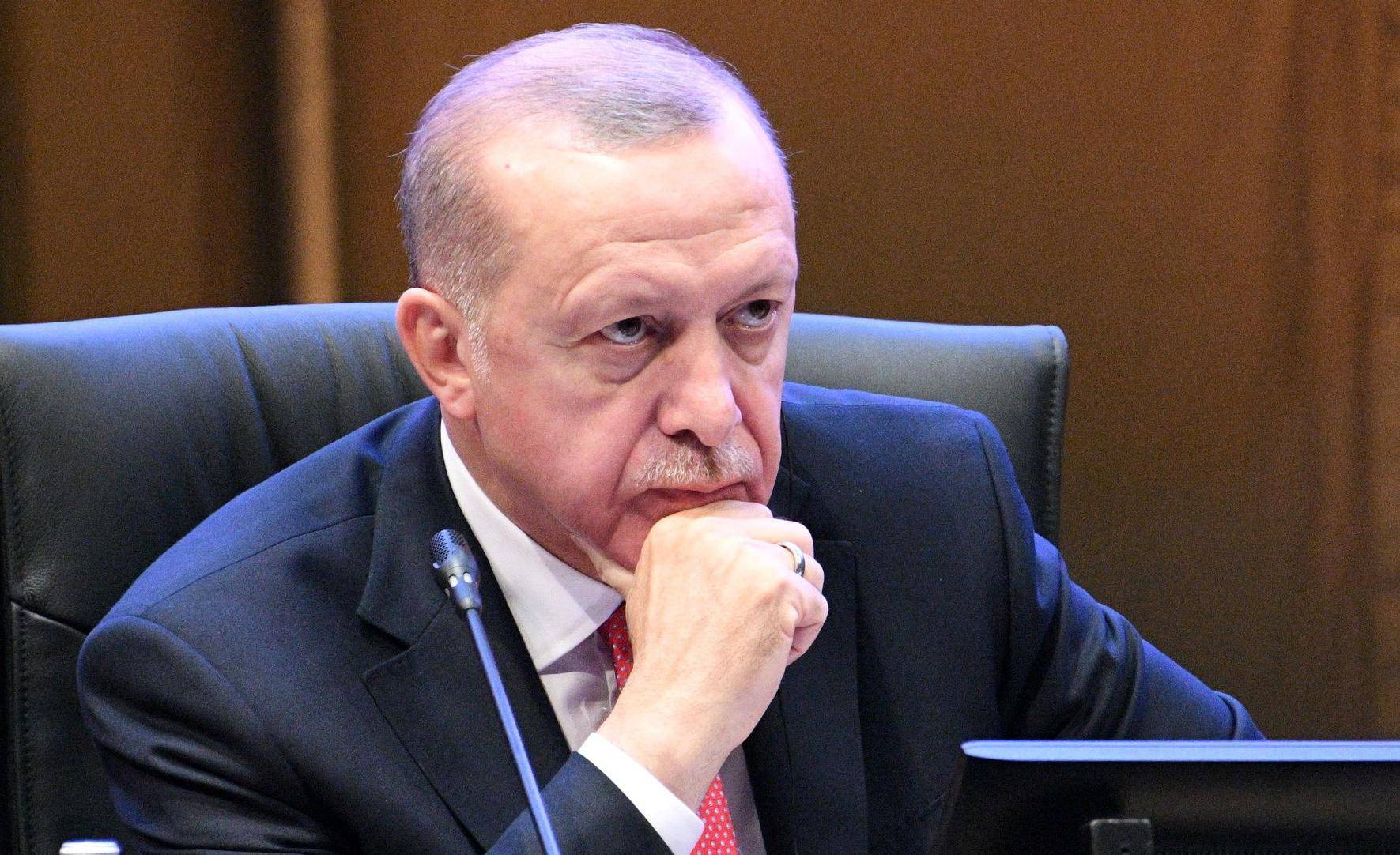 Turkey's President Recep Tayyip Erdogan reacts during a Kuala Lumpur Summit roundtable session in Kuala Lumpur