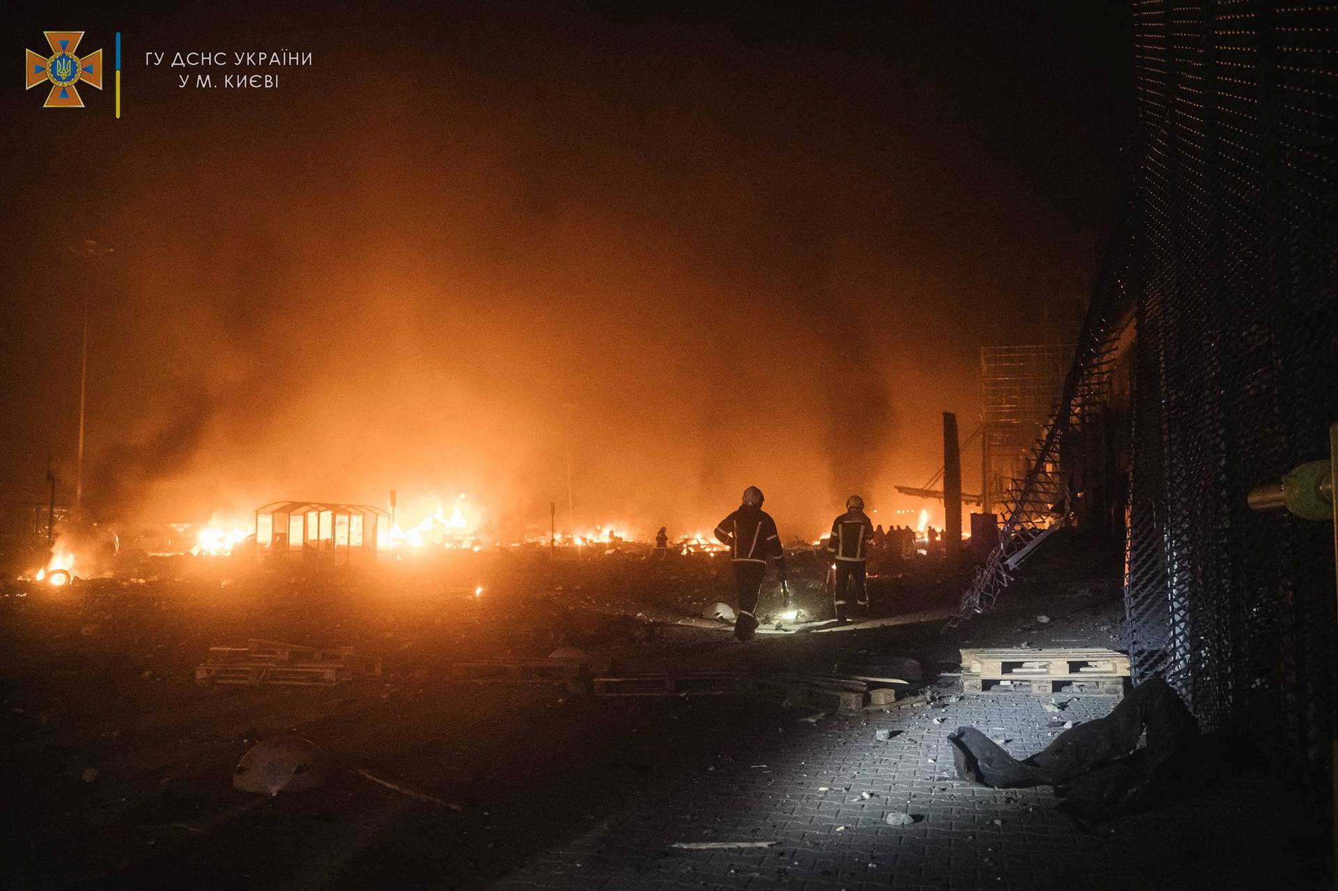 Rescuers work at the site of a shopping mall damaged by an airstrike in Kyiv