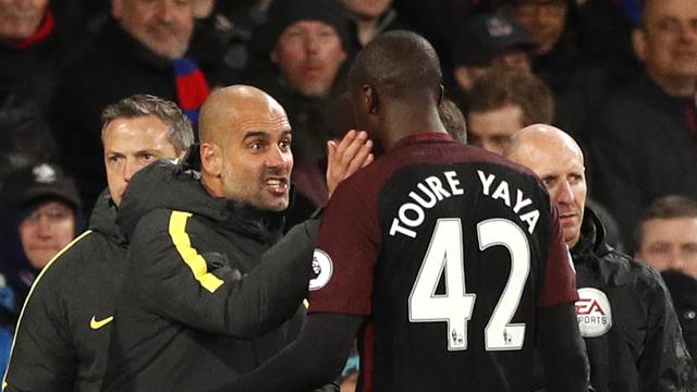 Manchester City manager Pep Guardiola speaks to Yaya Toure