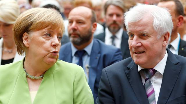 FILE PHOTO: German Chancellor Merkel and German Interior minister Seehofer attend an event to commemorate victims of displacement in Berlin