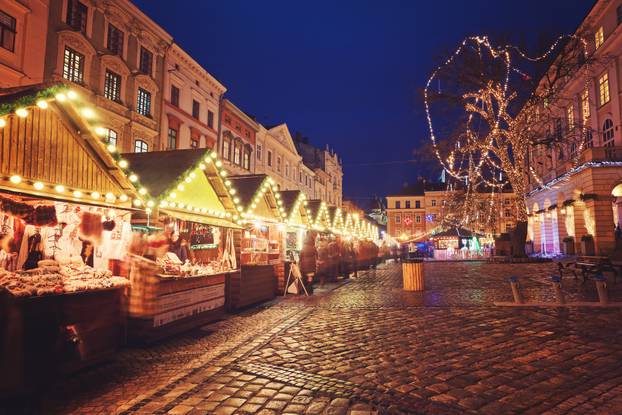 beautiful city center and wooden cabins for market covered in snow. snowy town square in Lviv.