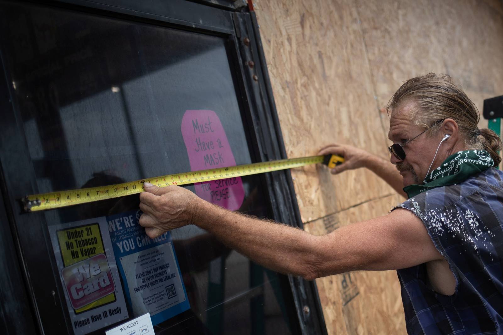 Man boards up convenient store ahead of Hurricane Laura in Galveston, Texas