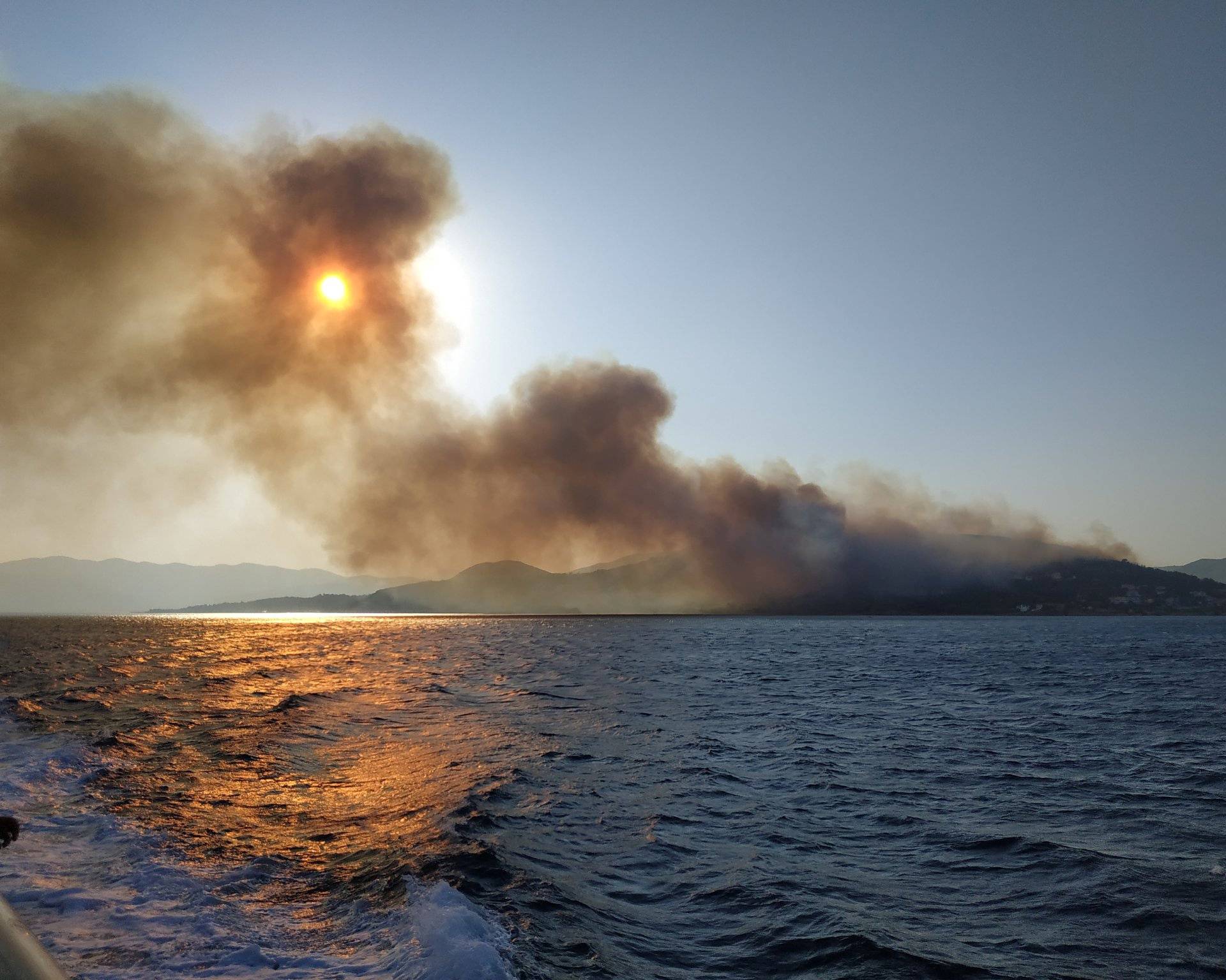 Smoke billows over the sea during a fire on Samos island
