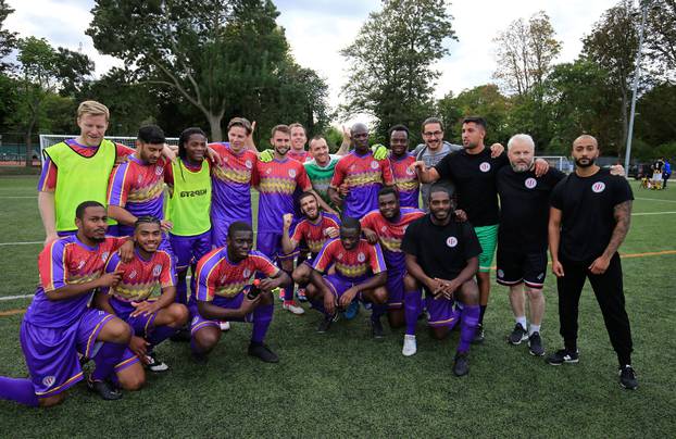 Clapton CFC players pose for pictures after winning their away game against Ealing Town in East Acton, in London