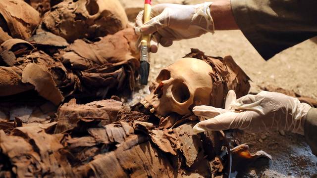 An Egyptian antiquities worker is seen in the recently discovered tomb of Amenemhat, a goldsmith from the New Kingdom, at the Draa Abu-el Naga necropolis near the Nile city of Luxor