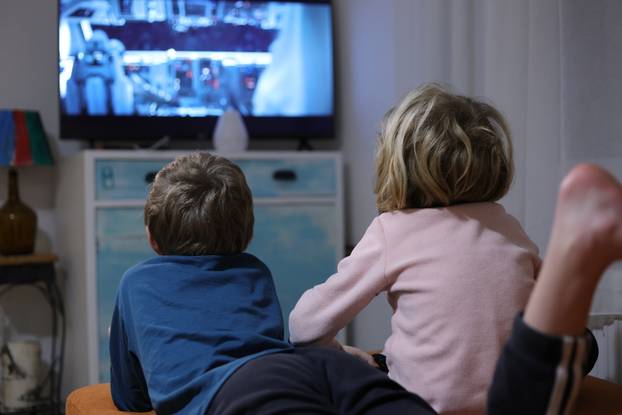 Two,Kids,Watching,Tv,In,The,Livingroom
