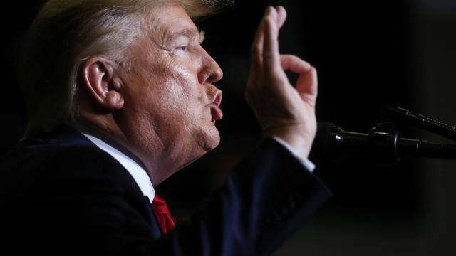 U.S. President Donald Trump reacts during a campaign rally in Tupelo