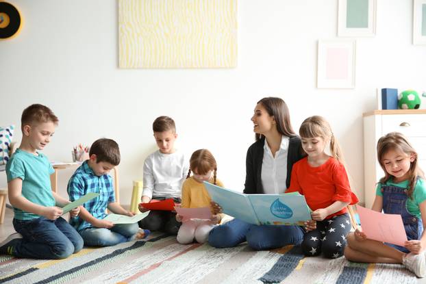 Cute,Little,Children,With,Teacher,In,Classroom,At,School