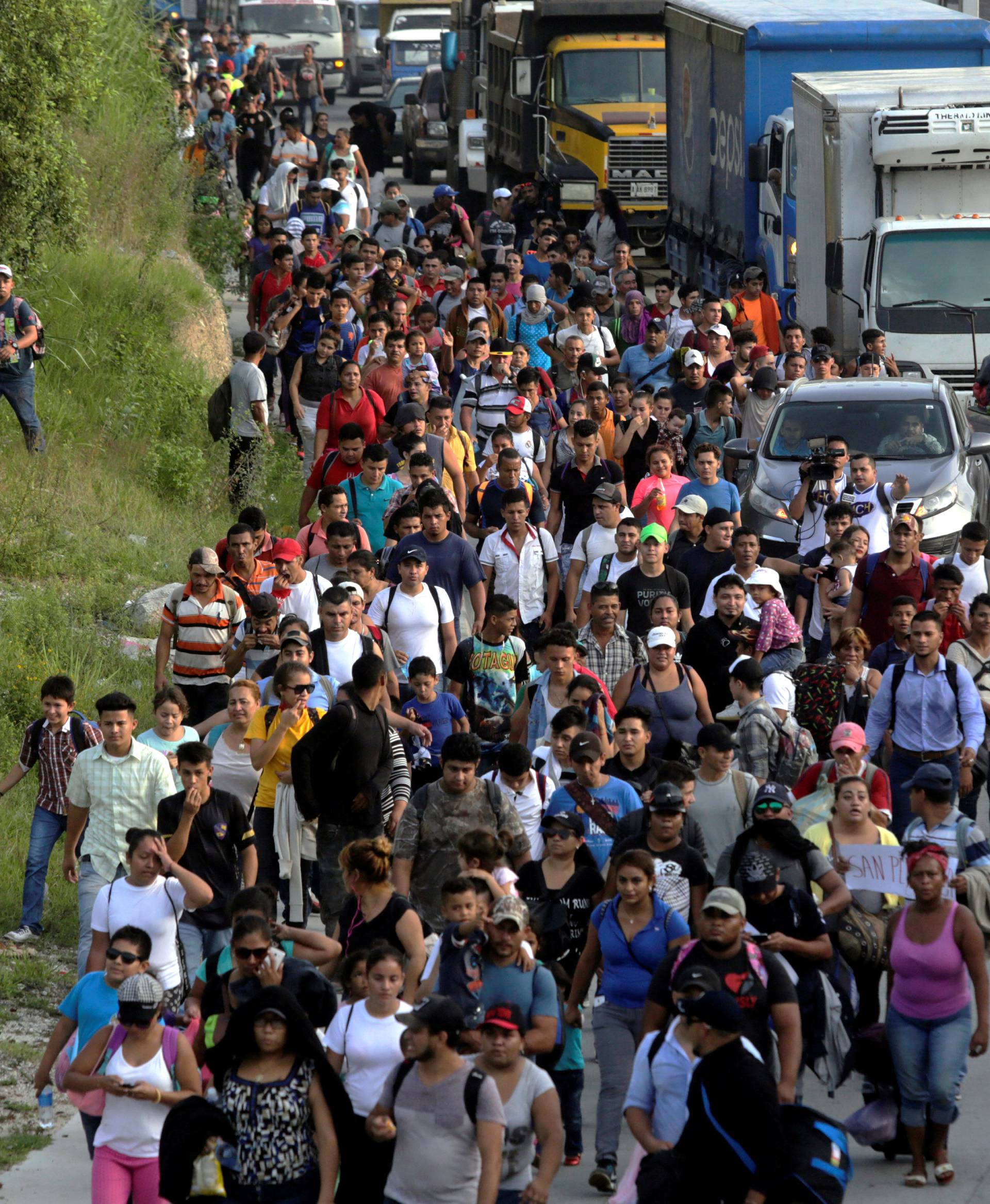 A large group of Hondurans fleeing poverty and violence, move in a caravan toward the United States, in San Pedro Sula