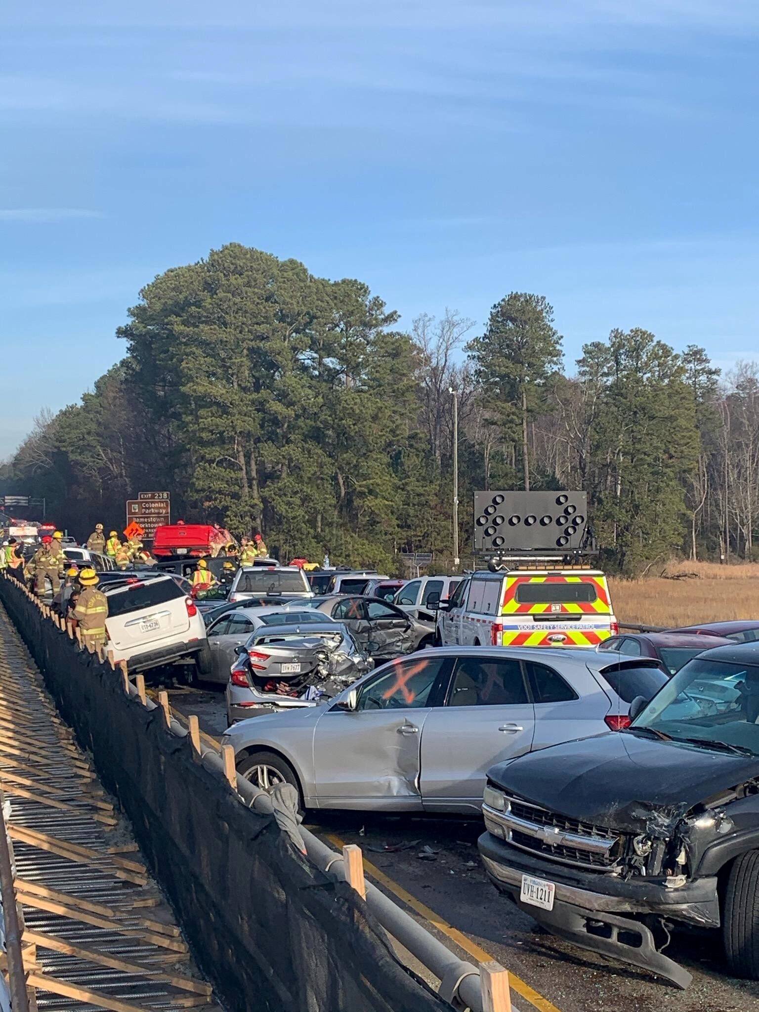 Damaged vehicles are seen after a chain reaction crash on I-64 in York County, Virginia
