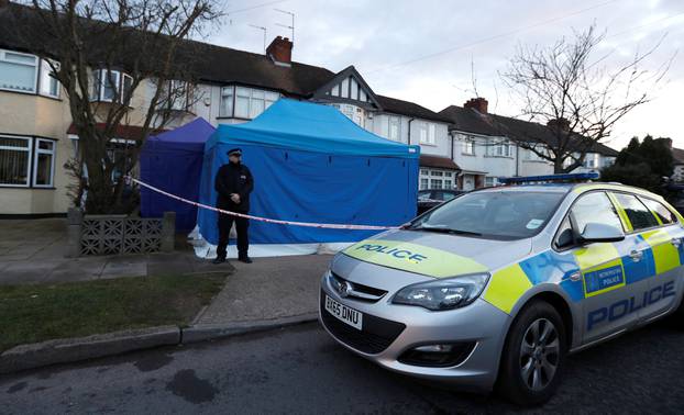 A police officer stands guard outside the home of Nikolai Glushkov in New Malden