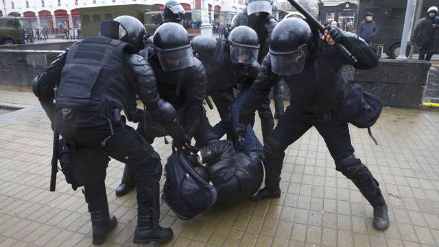 Law enforcement officers detain a participant of a rally marking the anniversary of the proclamation of the Belarussian People's Republic in Minsk