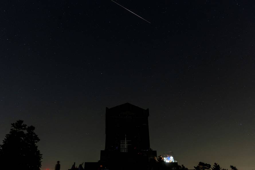 Meteors streak past stars in the night sky during the annual Perseid meteor shower above Belgrade