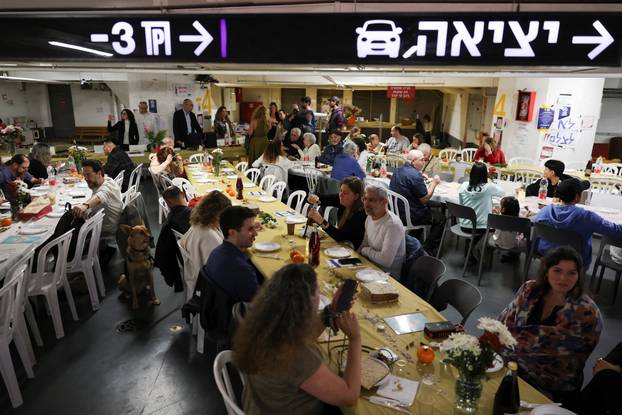 Israelis hold a Passover Seder in an underground parking garage used as a public bomb shelter, in Tel Aviv
