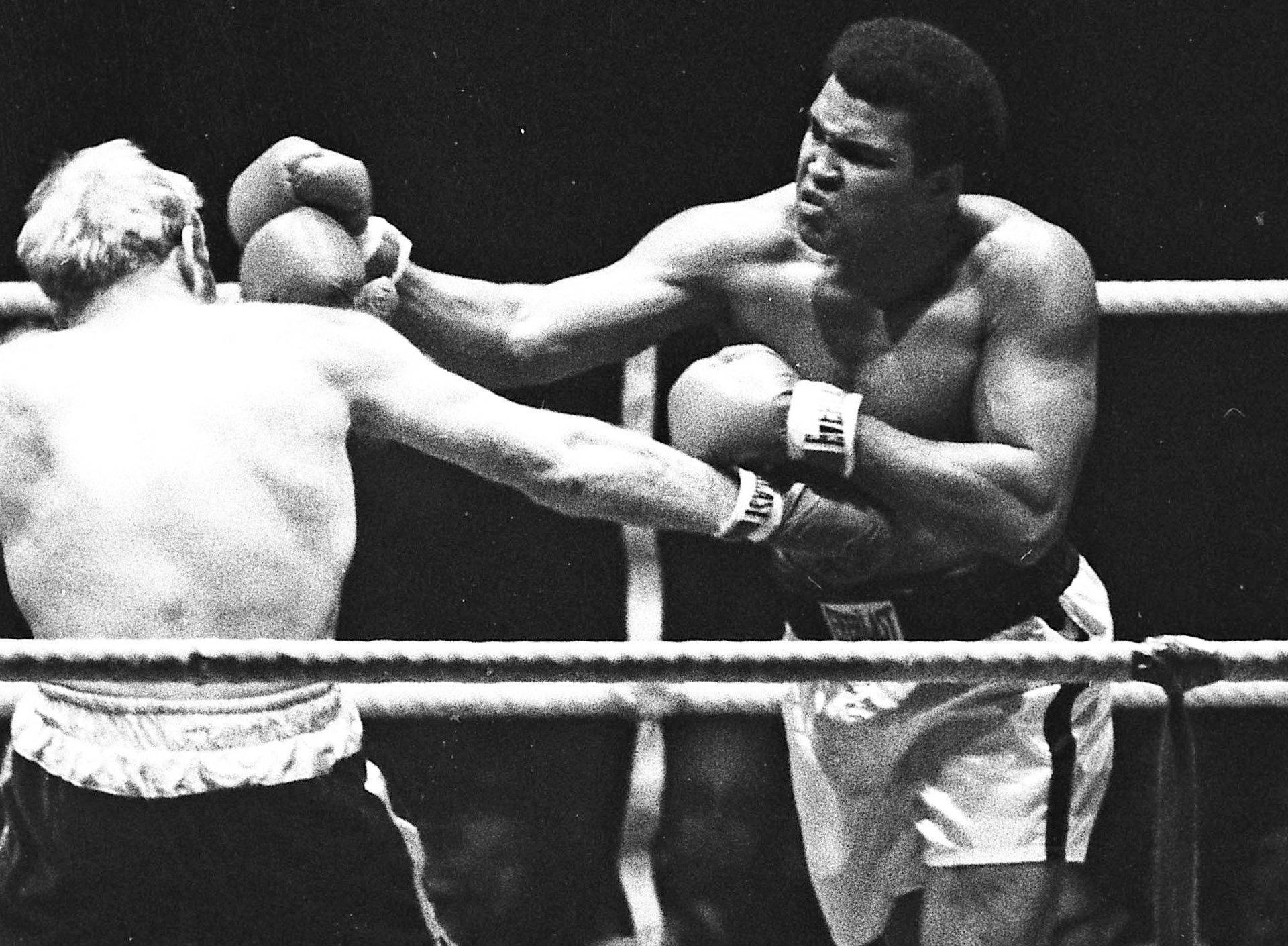 Muhammad Ali punches Richard Dunn while fighting for the WBC & WBA Heavyweight Title in Munich