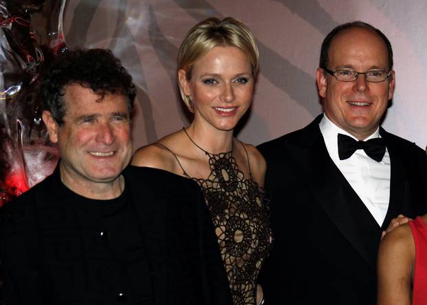 FILE PHOTO: Prince Albert II of Monaco (R) and his wife Princess Charlene arrive with South African singer Johnny Clegg (L) to attend the South Africa Gala night in Monaco
