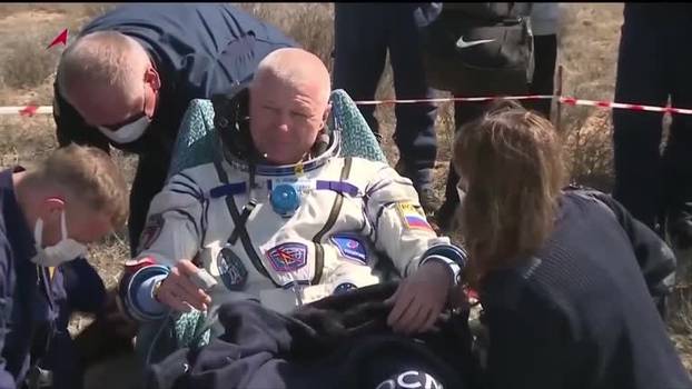 Soyuz astronauts emerge from space capsule after landing in Kazakhstan